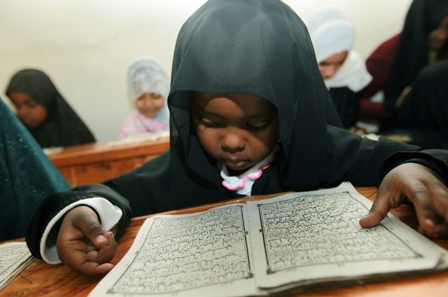 A Kenyan child reads verses from the Quran on the fifth day of the Muslim holy month of Ramadan in a Madrassa in Nairobi, Kenya on Wednesday, Aug. 26, 2009.