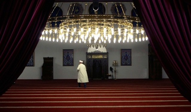 A man arrives for the evening prayers of the first day of the Islamic fasting month of Ramadan at Merkez mosque in Duisburg, Germany on August 21, 2009. 