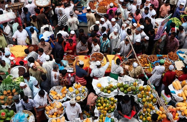 Muslims shop for Iftar, the sunset dinner that breaks the fast at Chalk Bazaar, the traditional Iftar market in Dhaka, Bangladesh on Sunday, Aug. 23, 2009. 