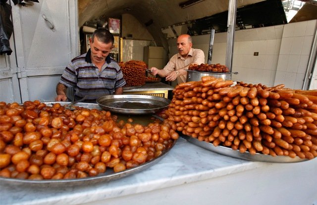 Palestinian vendors prepare trays of sweets for Ramadan, in a shop in the West Bank city of Nablus, Sunday, Aug. 23, 2009.