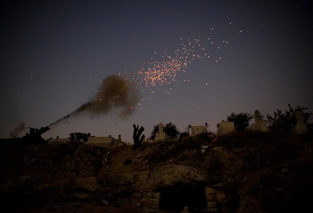 A cannon fires as part of the ceremony that ends the second day of the Muslim holy fasting month of Ramadan, outside Jerusalem's Old City Sunday, Aug. 23, 2009.