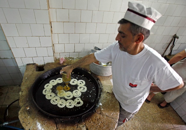 An Iraqi baker prepares sweets for the holy month of Ramadan in Baghdad, Iraq, Sunday, Aug. 23, 2009.