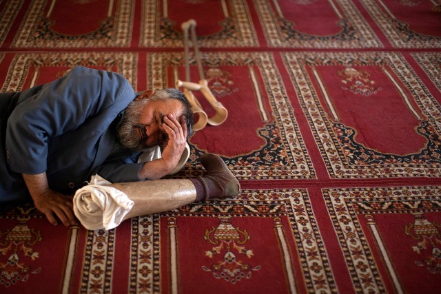 A man takes a nap in between prayers at a mosque in Kabul, Afghanistan on August 22, 2009.