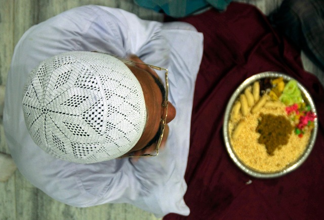 A Muslim man sits before breaking his fast on the second day of the holy month of Ramadan at a mosque in Agartala, capital of India's northeastern state of Tripura on August 24, 2009. 