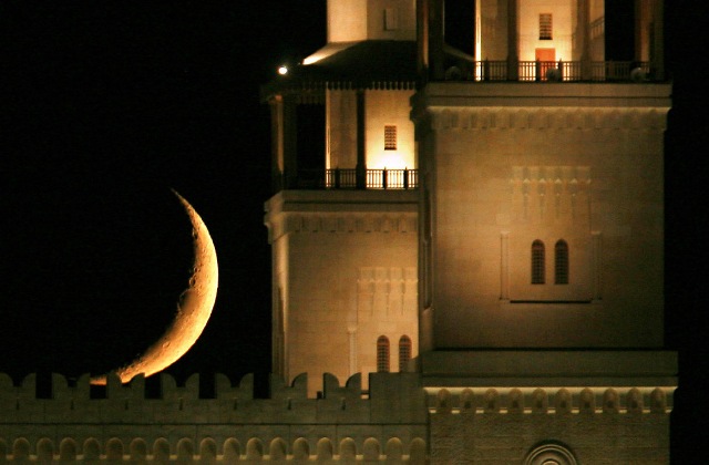 A crescent moon is seen behind the King Hussein Bin Talal Mosque in Amman, Jordan on August 23, 2009, during Ramadan.