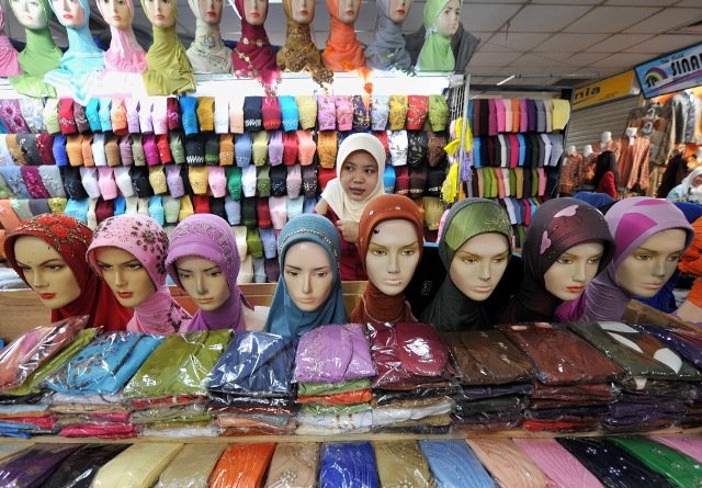 A vendor of headscarfs waits for customers in the 4th day of Ramadan at a market in Jakarta, Indonesia on August 25, 2009.