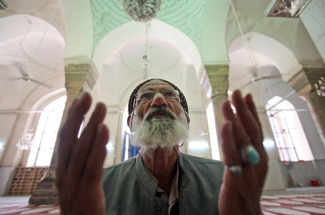 A man prays at a Sunni mosque in Baghdad, Iraq, Sunday, Aug. 23, 2009.